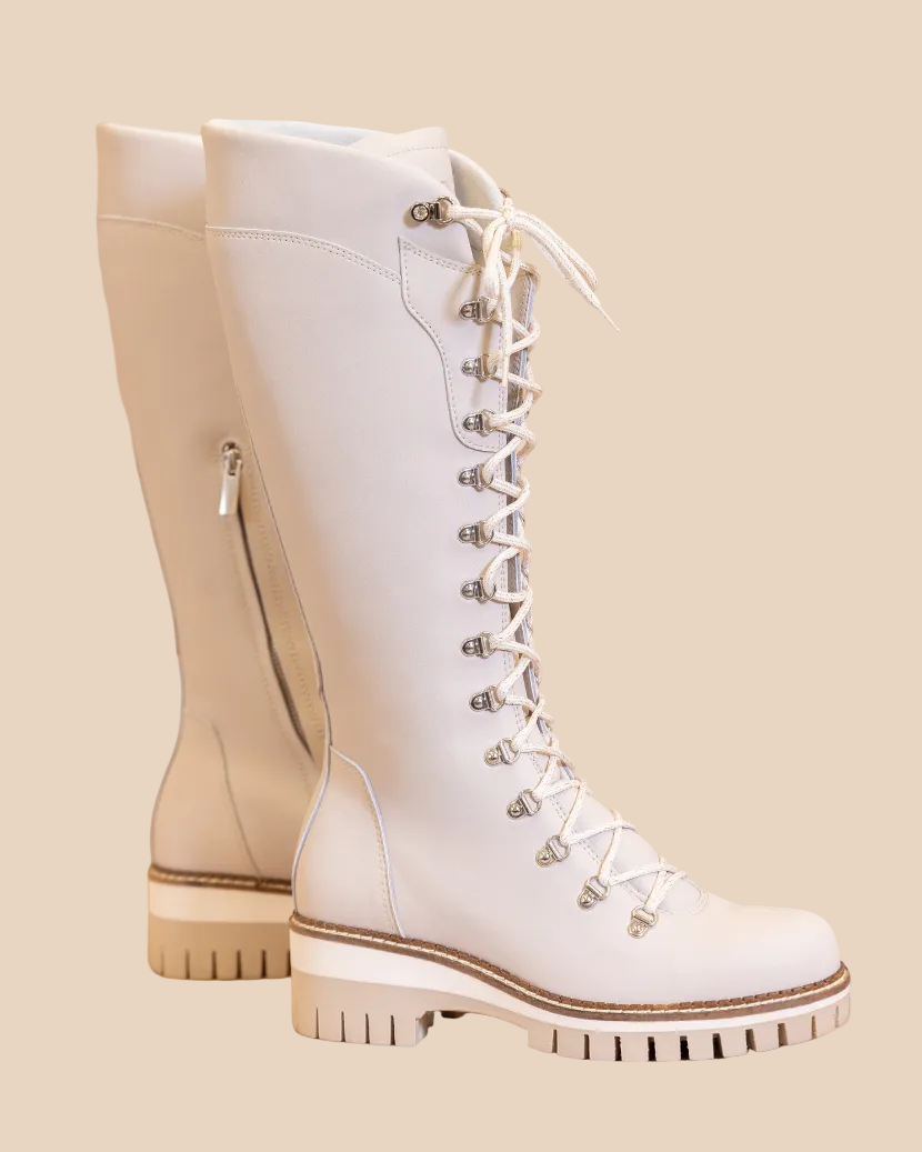 White lace-up boots on a beige background
